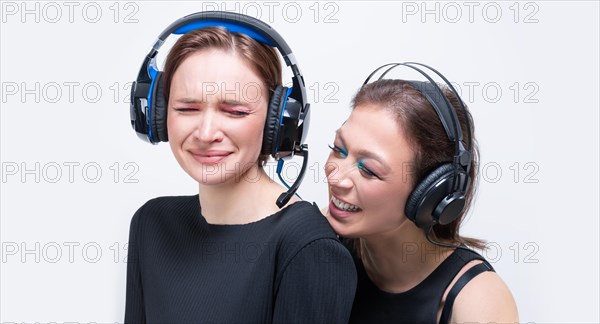 Portrait of two beautiful women with headsets. Technical support concept.