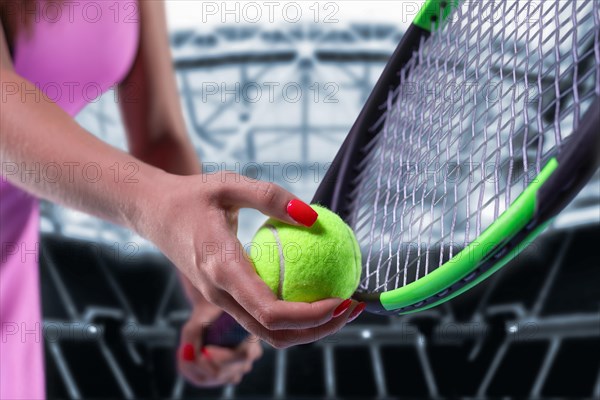 Portrait of a tennis player in a pink dress against the background of a sports arena.