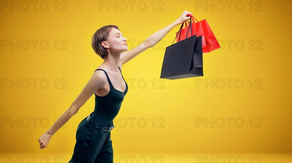 Portrait of a beautiful woman with packages. She enthusiastically rushes shopping. Shopaholic concept. Shopping centers. Sales.