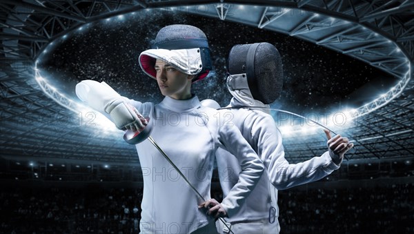 Portrait of two fencers against the backdrop of a sports arena. The concept of fencing. Duel.