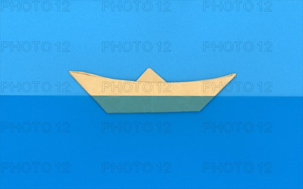 Paper boat in the sea