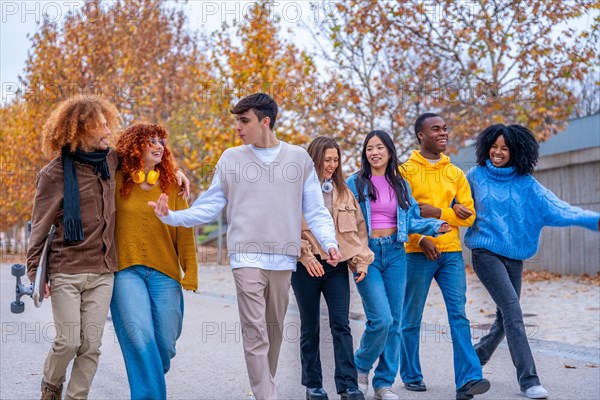 Multi-ethnic students walking along the campus chatting and embracing