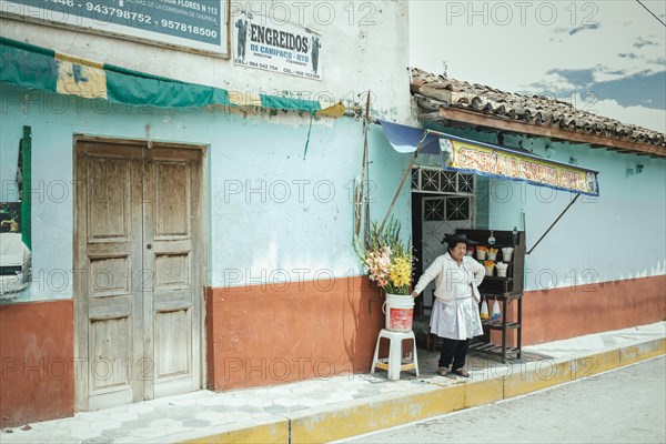 Woman in front of her devotional shop