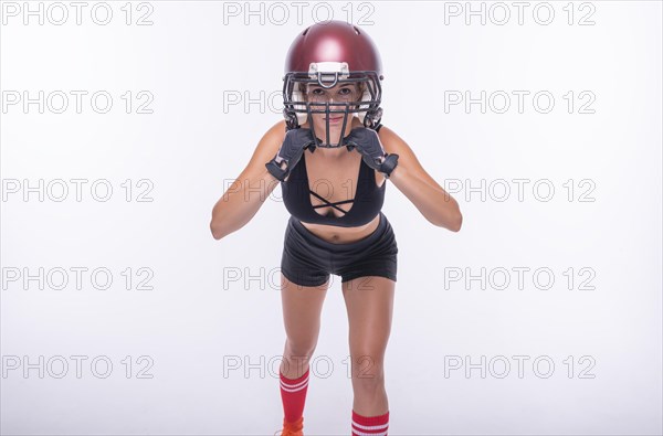 Woman in the uniform of an American football team player posing on a white background. Sports concept.