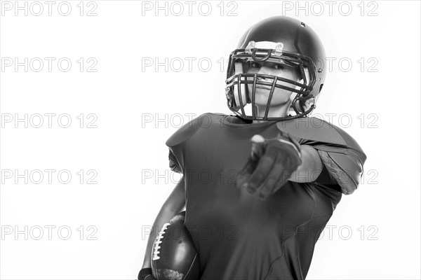 Black and white images of a sports girl in the uniform of an American football team player. Sports concept. White background.