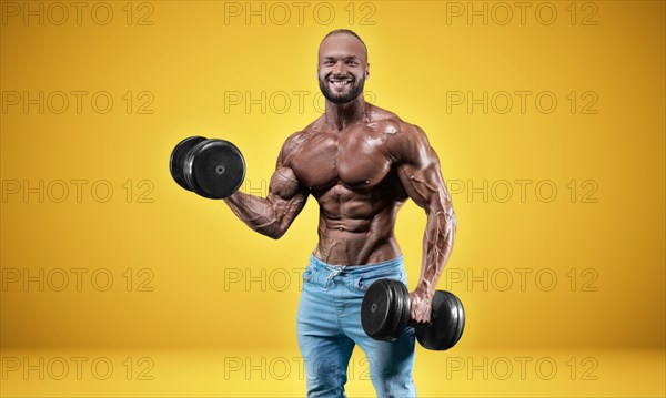 Isolated professional sportsman on a yellow background. Bodybuilding concept. Panorama. Advertising of a gym and sports nutrition.