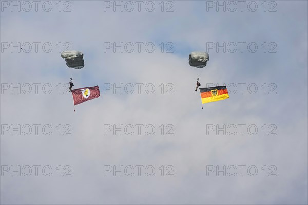 Bundeswehr parachutist with German flag. Spotterday for the Day of the German Armed Forces at Bueckeburg Army Airfield