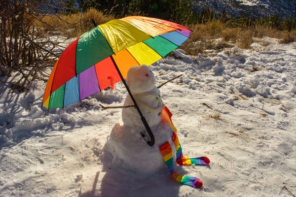Snowman with umbrella in lgtb pride colors