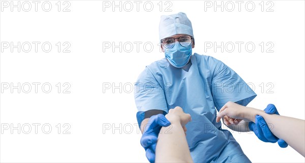 Portrait of a doctor in a mask on a white background. He holds the patient's hands. Medicine concept.