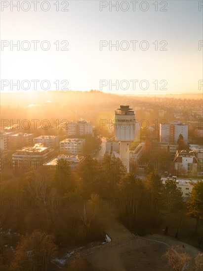 Golden dawn with a view of a municipal water tower