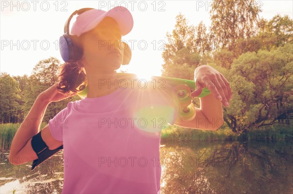 Portrait of a teenage girl with a skateboard. Sports lifestyle concept.