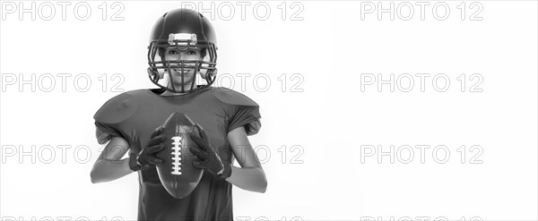 Black and white images of a sports girl in the uniform of an American football team player. Sports concept. White background.