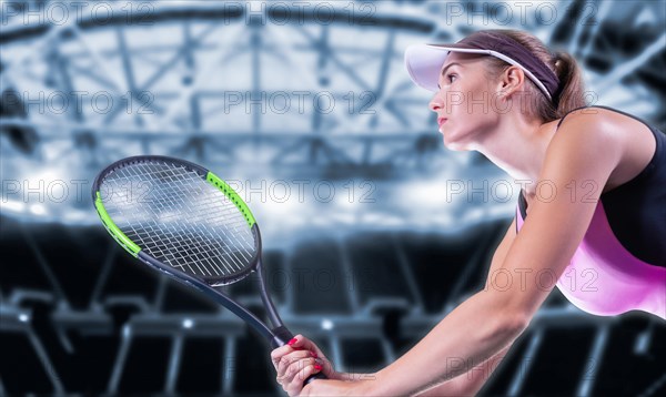 Portrait of a tennis player in a pink dress against the background of a sports arena.