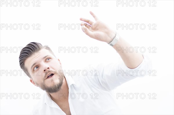 Stylish man in a shirt shows an ok sign right at the camera. The concept of success and support