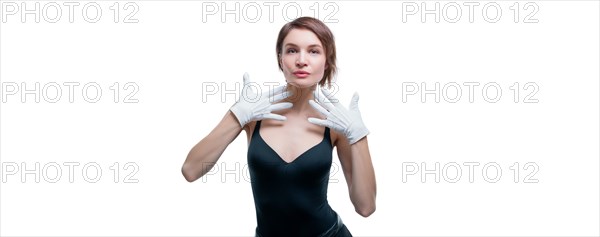 Surprised beautiful young woman in white gloves posing in the studio on a white background.