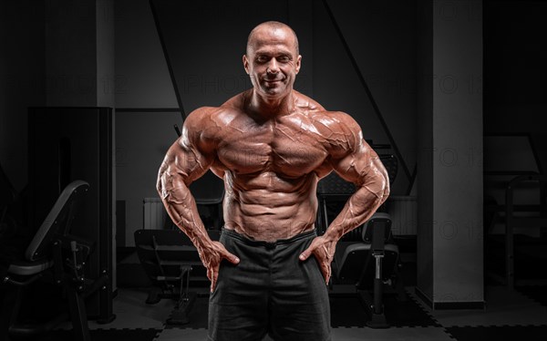 Professional weightlifter posing in the gym. Classic bodybuilding.