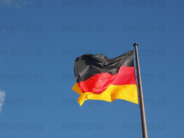 German flag over blue sky