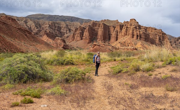 Climber in a canyon with a dry stream bed