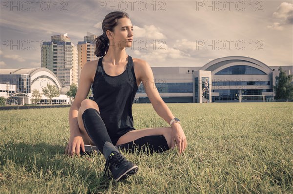 The football player is resting on the football field. Sports concept.