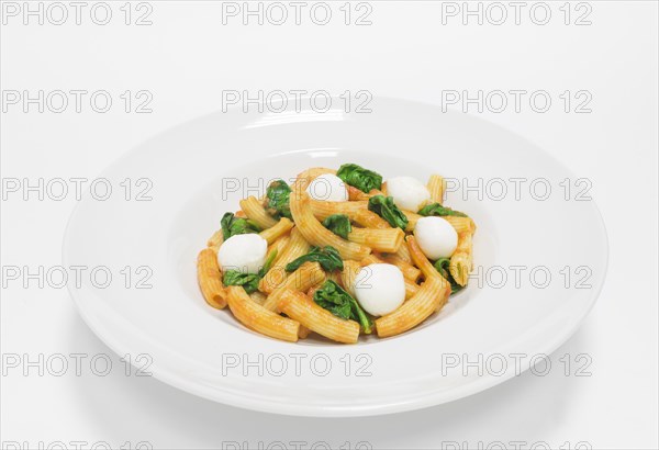 Gourmet pasta with basil and mozzarella balls. Top view. White background. Healthy eating concept.