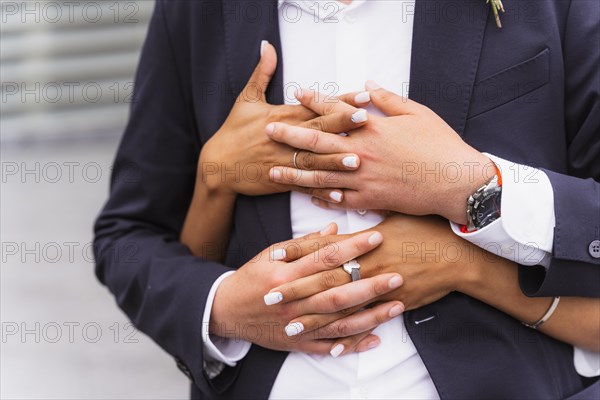 Multiethnic couple embracing with ring at a beautiful wedding