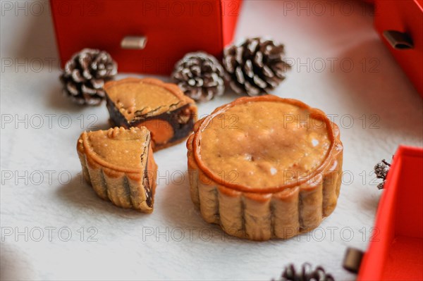 A single mooncake piece placed prominently with a festive backdrop