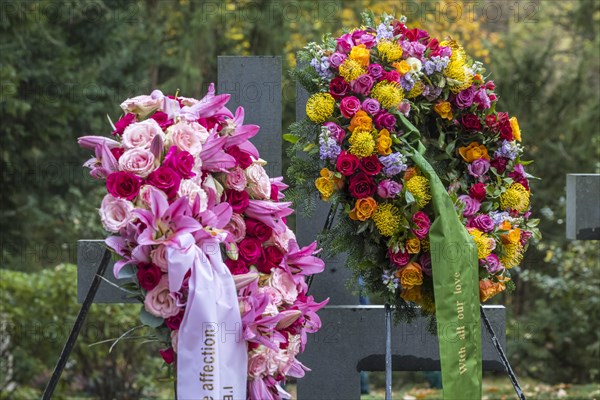 Funeral wreath with flowers at a grave