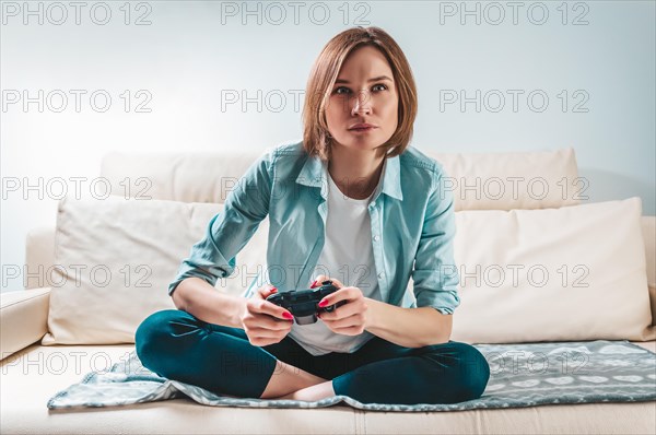 Portrait of a girl with a joystick in her hands. The concept of video games