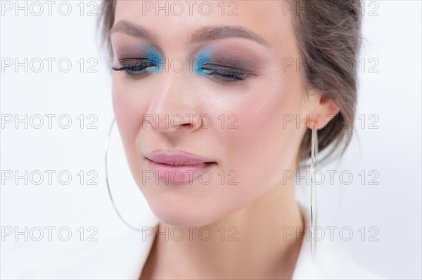 Portrait of a beautiful girl with a defiant make-up. White background. Beauty concept. High quality