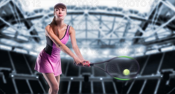 Portrait of a tennis player in a pink dress against the background of a sports arena.