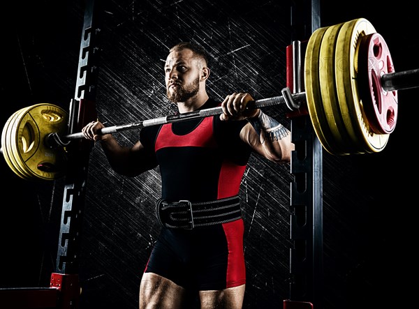 Professional athlete prepares to squat with a barbell.