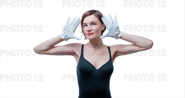 Surprised beautiful young woman in white gloves posing in the studio on a white background.