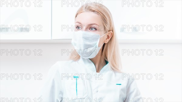 Portrait of a blonde girl in a mask. Coronavirus epidemic concept. Pandemic.