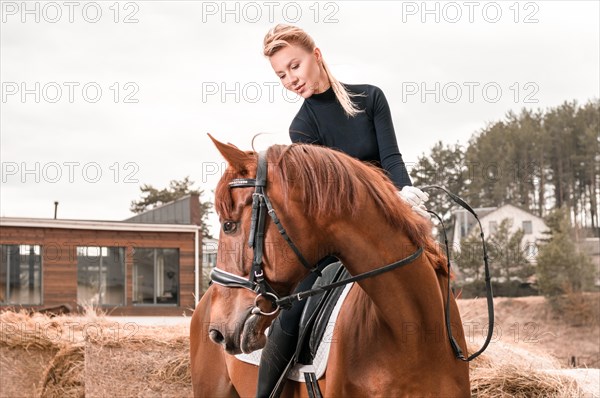 Beautiful woman rides a horse. Equestrian sport concept.