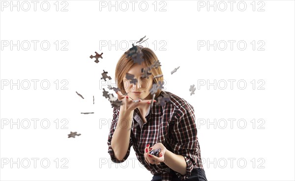 Cute girl sprinkles around puzzles. The concept of preschool and home schooling. Funny board games.