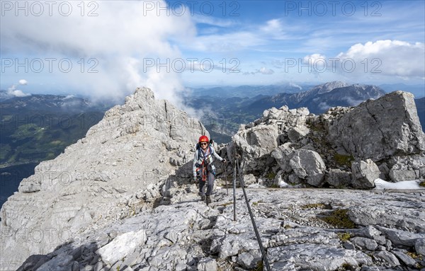 Climber on a via ferrata secured with a steel cable