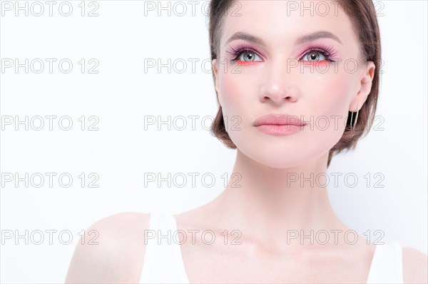 Portrait of a beautiful girl with provocative makeup. White background. Beauty concept. High quality