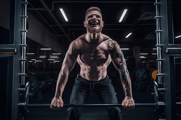 Portrait of an athlete performing a deadlift in the gym. Bodybuilding and fitness concept.