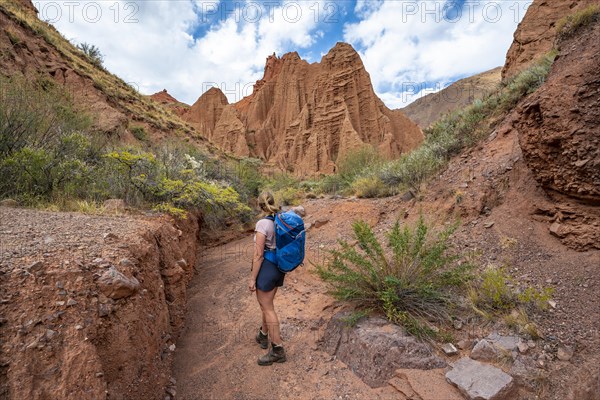 Climber in a canyon with a dry stream bed