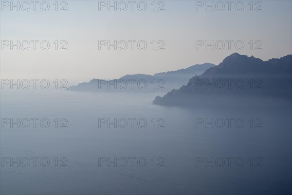 View of a Corsican coastal landscape in fog as texture or background