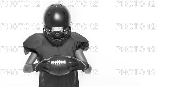 Black and white images of a sports girl in the uniform of an American football team player. Sports concept. White background.