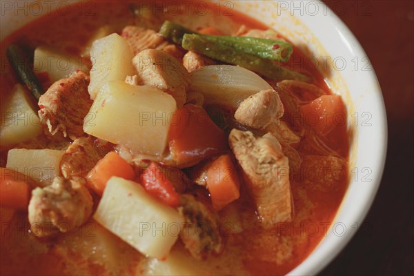 A bowl of hearty chicken stew with potatoes