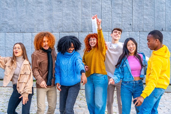 Frontal view of free and happy multi-ethnic friends dancing in the street