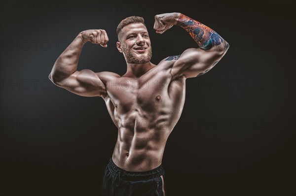 Young muscular guy posing in the studio. Fitness and nutrition concept.