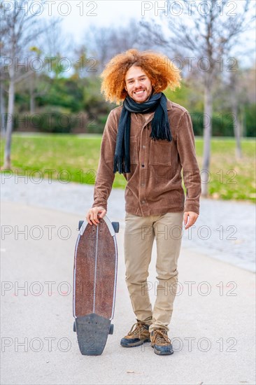 Vertical portrait of an skater in an urban park in autumn