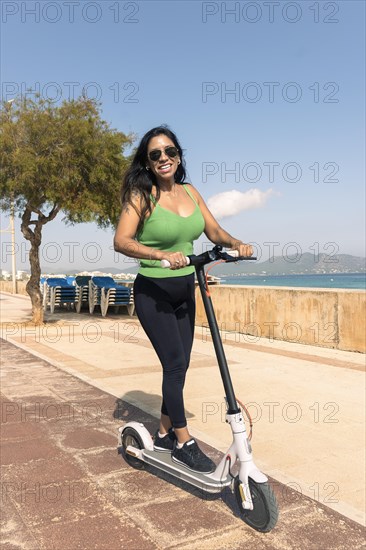 Woman riding electric scooter