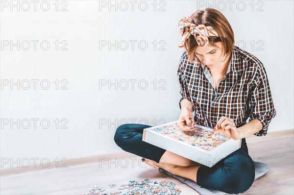 Teenager plays puzzles. The concept of board educational games. Stay at home.