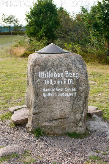Summit stone on the Wilseder Berg with metal plate and height indication
