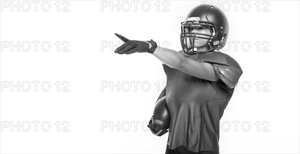 Black and white images of a sports girl in the uniform of an American football team player. Sports concept. White background.