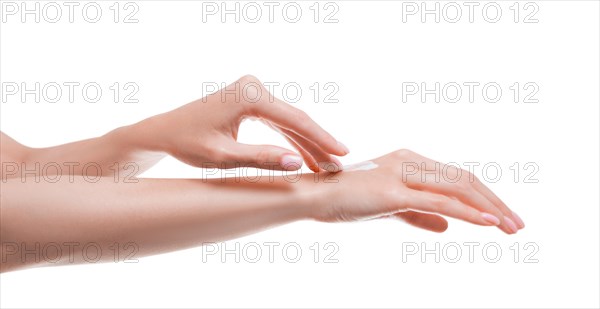 Image of female hands applying cream to the skin. Medical concept of healthy skin and hand care.